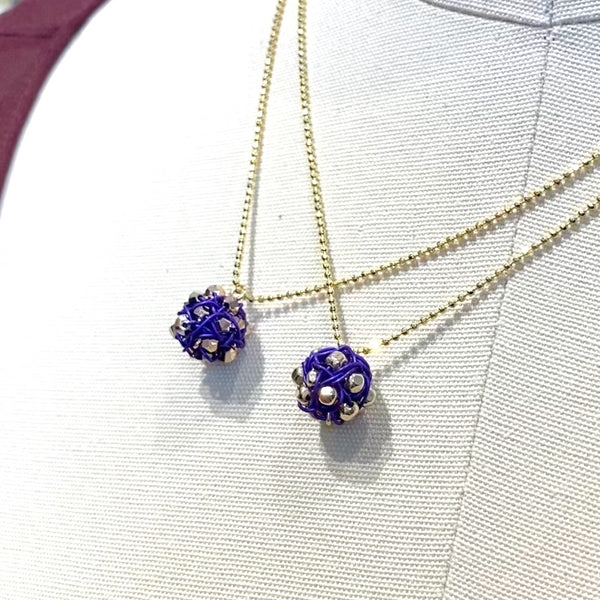 Purple and gold tiny round woven pendants made by artist Ree Gallagher 