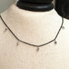 Choker tassel necklace created by Ree Gallagher using thing black stainless steel chain with 5 silver mirror 2mm Swarovski crystals dangling from black chain on sterling wires and can be worn 14 - 16 inches